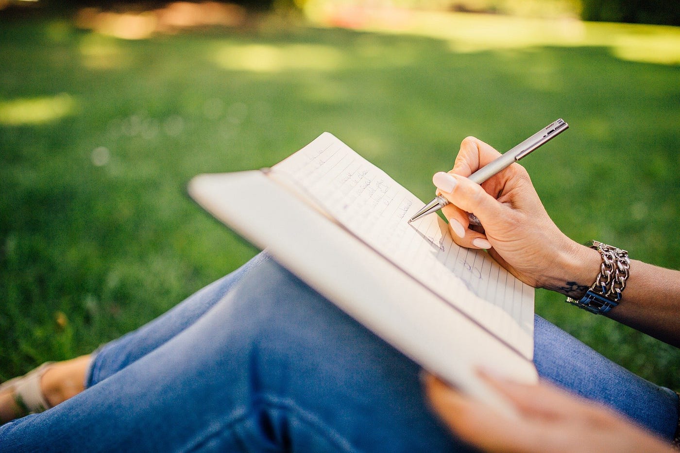 A person journaling in a notebook as part of their healing process