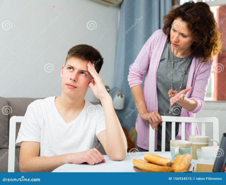 A parent talking seriously with their teenager at home